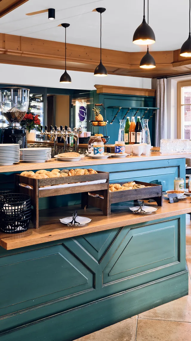 Cozy café breakfast buffet with pastries, coffee machine, and rustic wooden decor