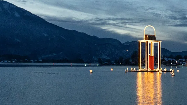 St. Wolfgang village and illuminated Christmas lantern on Lake Wolfgang at twilight
