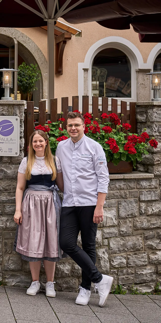 Team of chefs and staff posing in front of Paula gourmet restaurant entrance